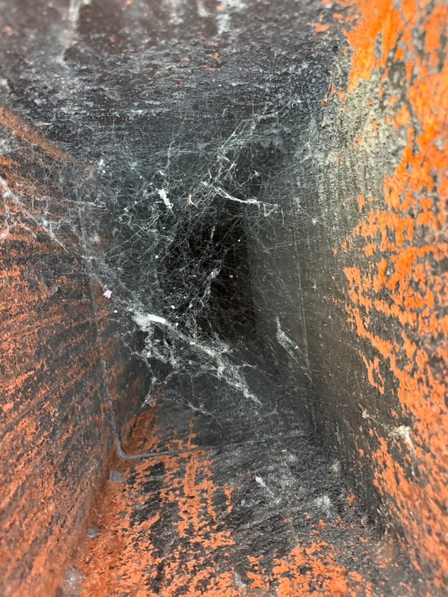 Inside a chimney before cleaning, showing buildup and debris